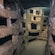 A tunnel with stairs and a stone wall in the catacombs of Rome